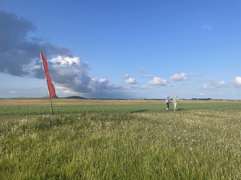 Photograph of participants experincing the soundwalk on location on Benbecula. Photo Credit: Tara Drummie.