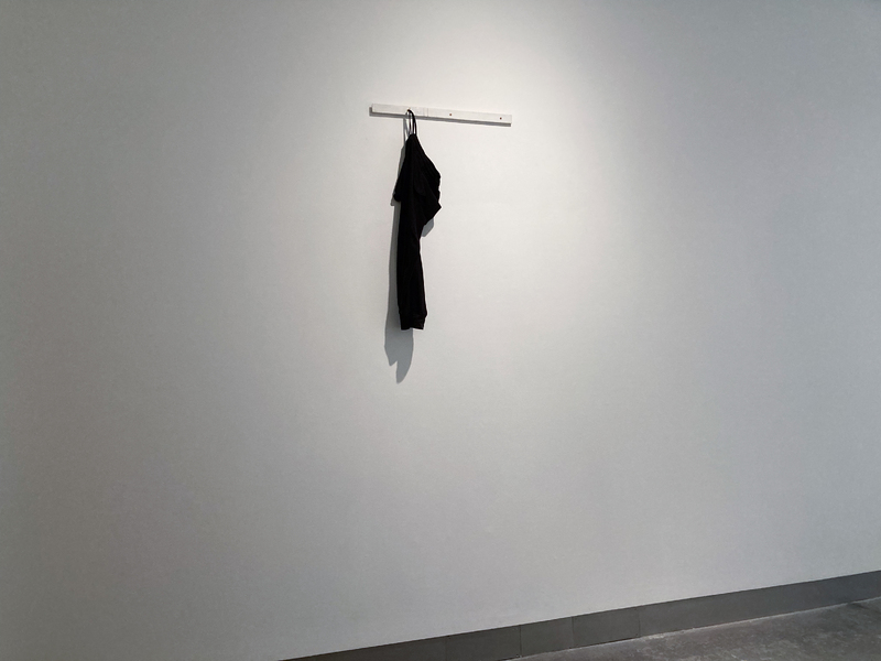 ‘Umbilical (07777688920)’  SMITH/STEWART 2026 (tracksuit bottoms, mobile phone, sound, painted wood, screws)