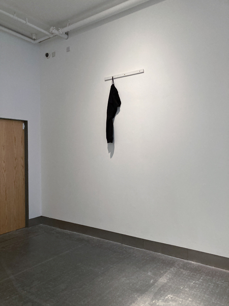 ‘Umbilical (07777688920)’  SMITH/STEWART 2026 (tracksuit bottoms, mobile phone, sound, painted wood, screws)