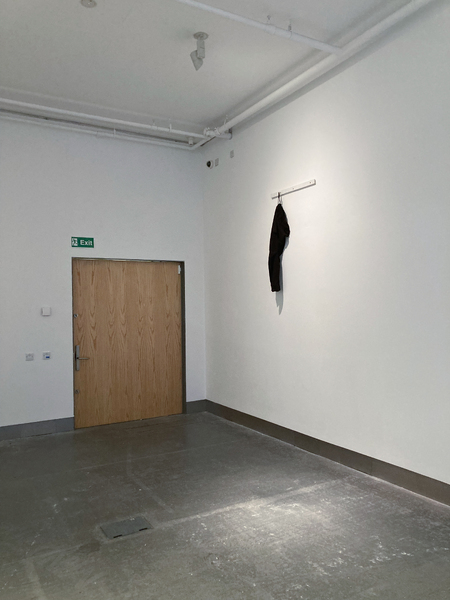 ‘Umbilical (07777688920)’  SMITH/STEWART 2026 (tracksuit bottoms, mobile phone, sound, painted wood, screws)