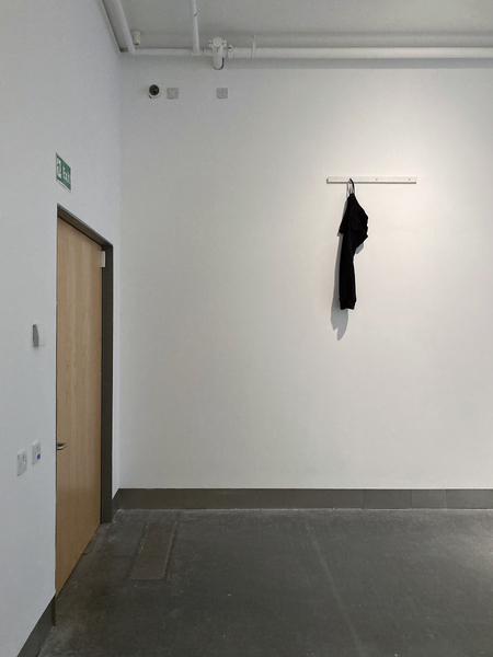 ‘Umbilical (07777688920)’  SMITH/STEWART 2026 (tracksuit bottoms, mobile phone, sound, painted wood, screws)