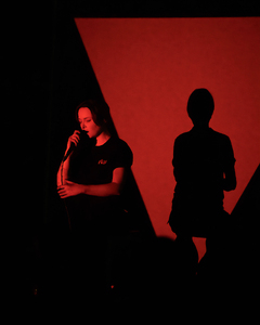 Performance documentation image of (red triangle), presented at CAC Late, City Art Centre, Edinburgh, 2025. Photograph by Ian Georgeson