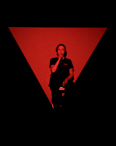 Performance documentation image of (red triangle), presented at CAC Late, City Art Centre, Edinburgh, 2025. Photograph by Ian Georgeson